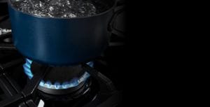 Close-up of pot of boiling water on a gas cooktop burner