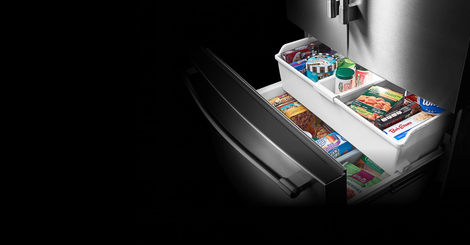 A stainless steel Maytag fridge with its bottom freezer door open.