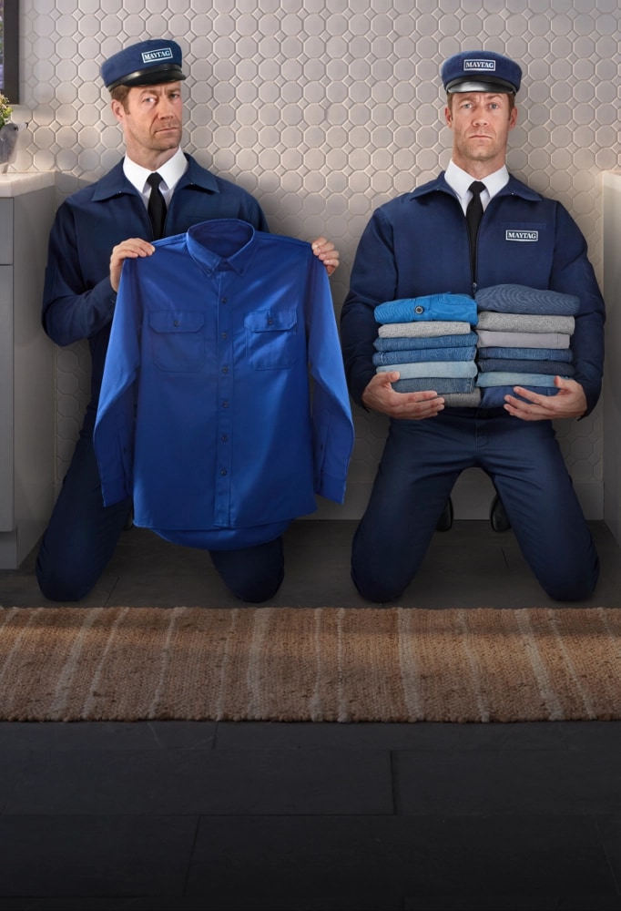 The Maytag® Man as holding laundry, next to a dog.