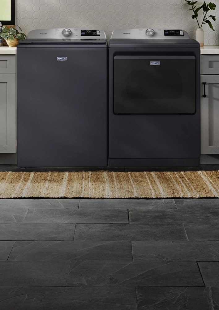 A Maytag® washer and dryer pair in a laundry room.