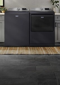 A Maytag® washer and dryer pair in a laundry room.