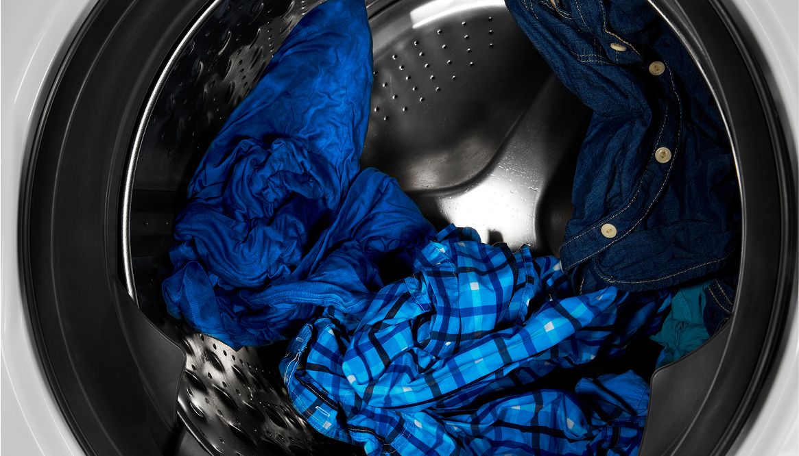 Clothes tumbling in washer at night.