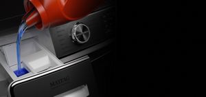 Detergent being poured into a dispenser.