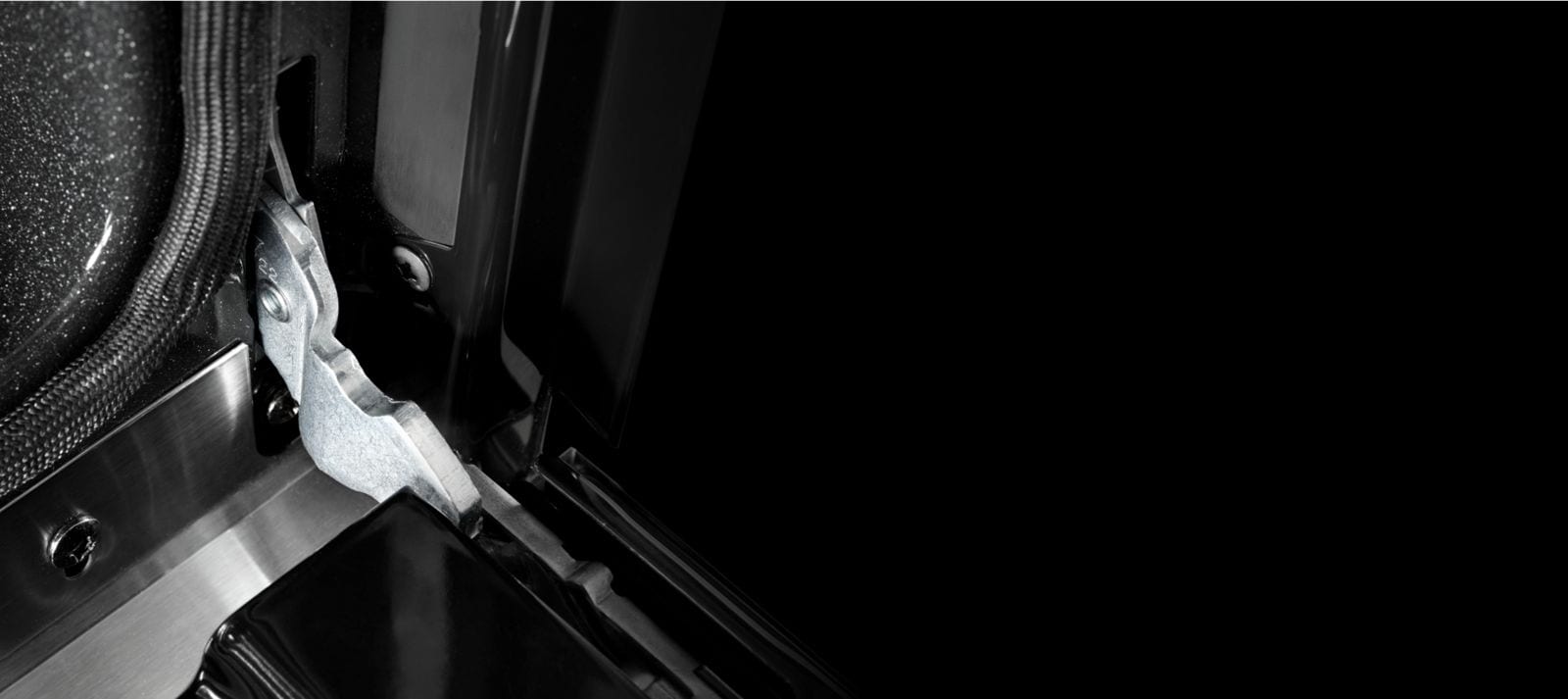 Close-up of wall oven door hinges.