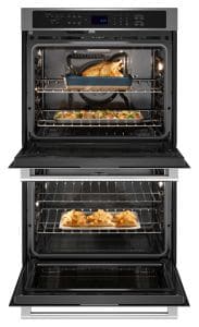 A stainless steel double wall oven, open with food inside.
