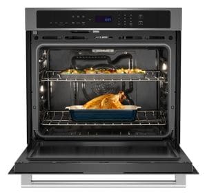 A stainless steel single wall oven, open with food inside.