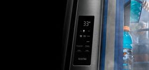 A closeup of an open refrigerator door with items inside.