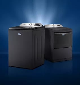 A Maytag® washer and dryer with a light behind it