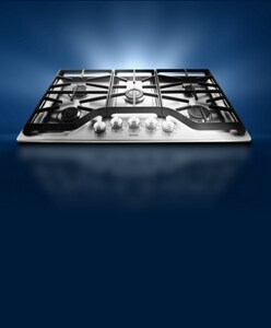 An electric cooktop against a dark background.