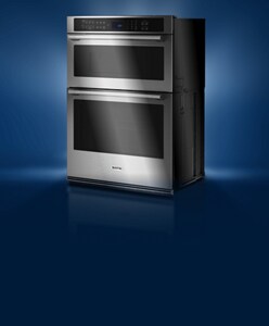 A Maytag® stainless steel wall oven silhouetted on a blue background.