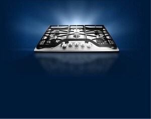 An electric cooktop against a dark background.