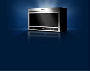 A Maytag® stainless steel microwave with light streaming in from behind