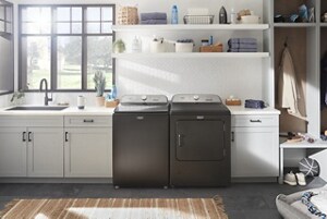 A pair of Maytag® washers and dryers in a white laundry room